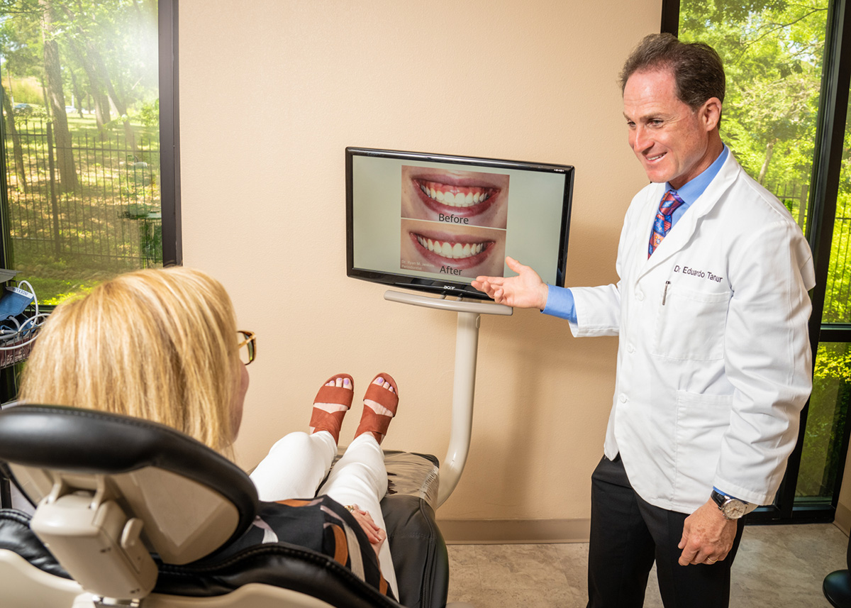 Dr. Tanur speaks to a patient about a before/after treatment