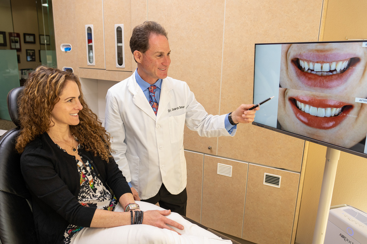 Dr. Tanur showing a patient a before/after image