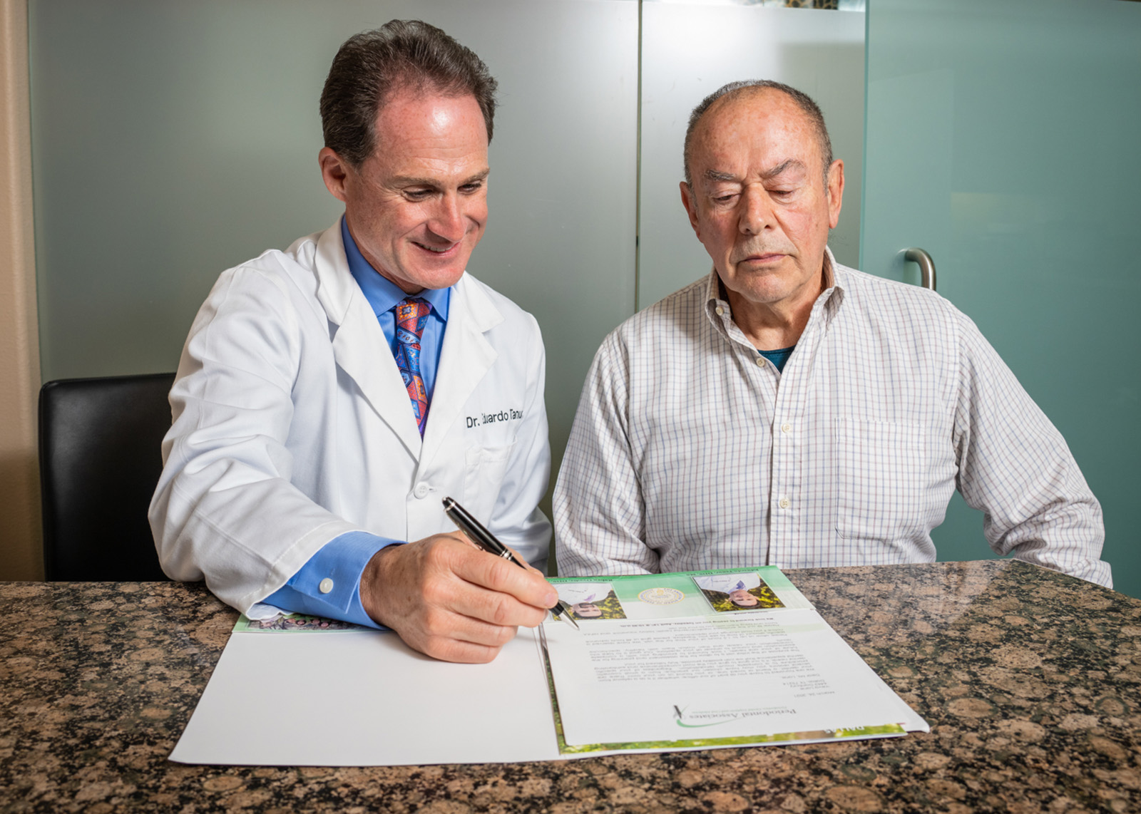 Dr. Ovadia and a patient looking into paperwork together