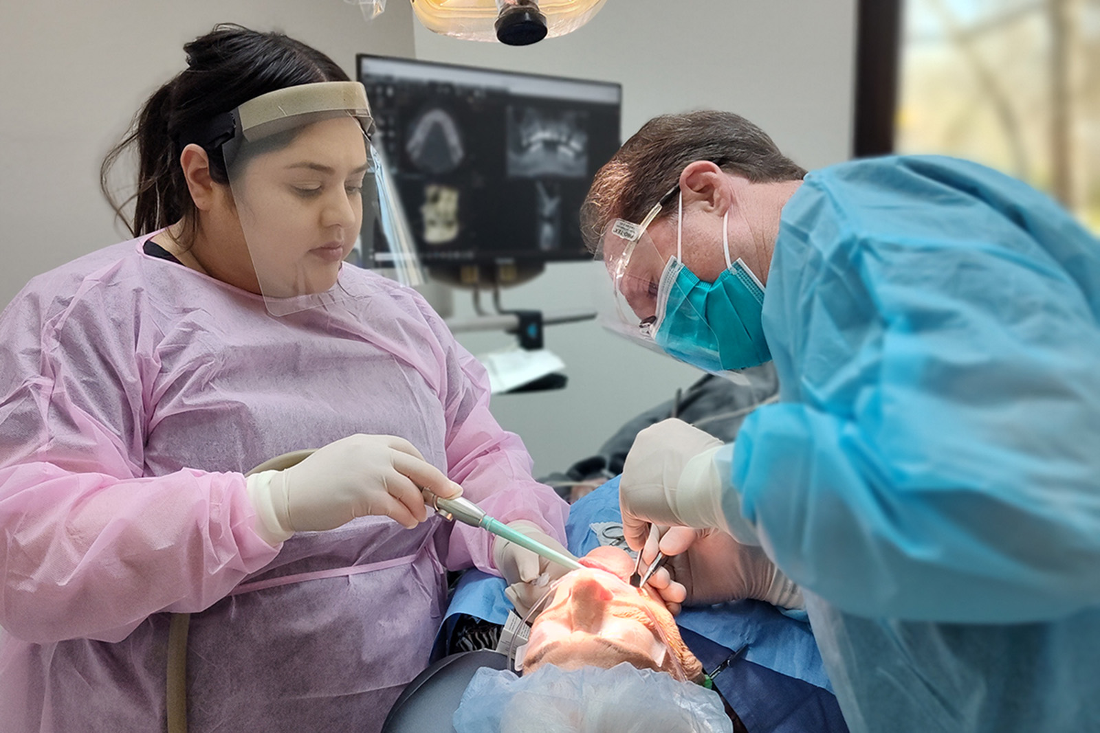 Dr. Tanur and an assistant operate on a patient