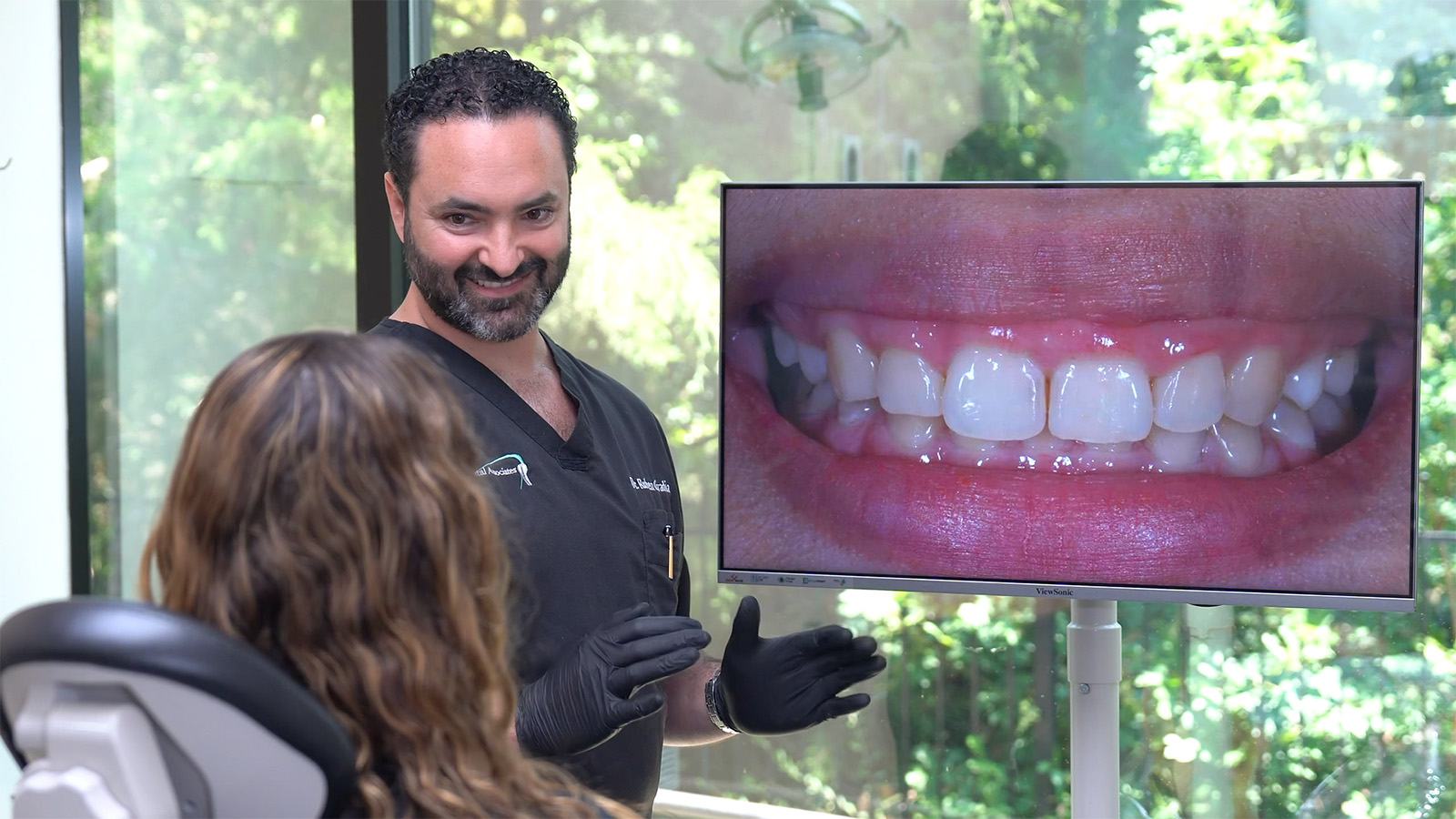 Dr. Ovadia discussing with a patient oral hygiene