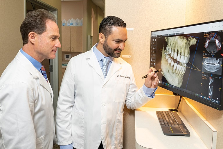 Image of Dr. Ovadia and Dr. Tanur planning treatments in their dental practice.