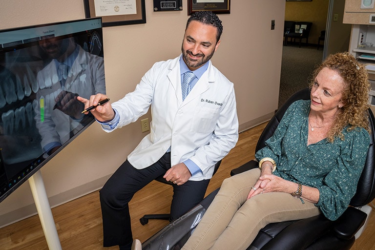 Dr. Ovadia explaining the bone grafting procedure to a patient during a consultation.